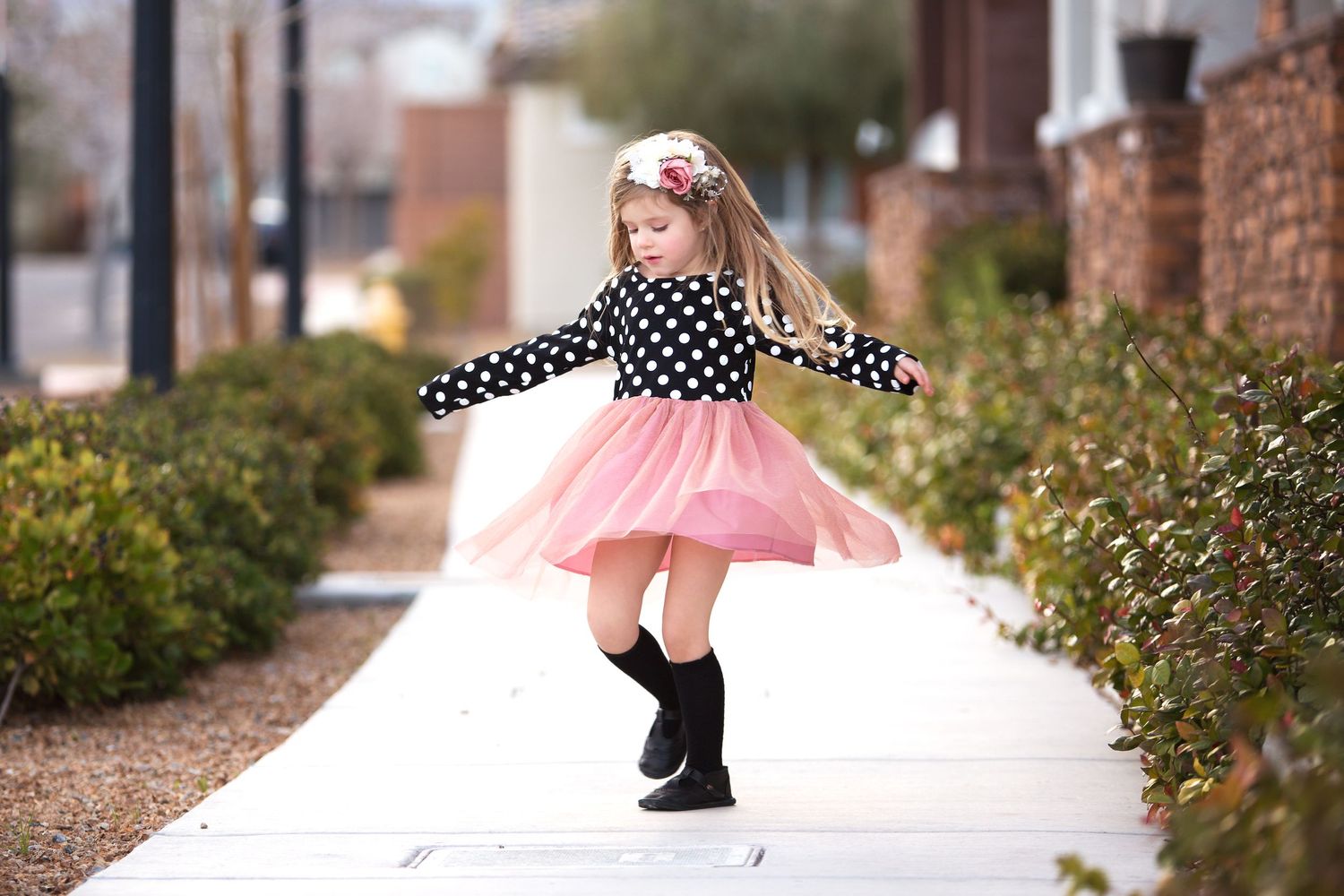 Dancing figure in pink tulle skirt photographed outdoors.