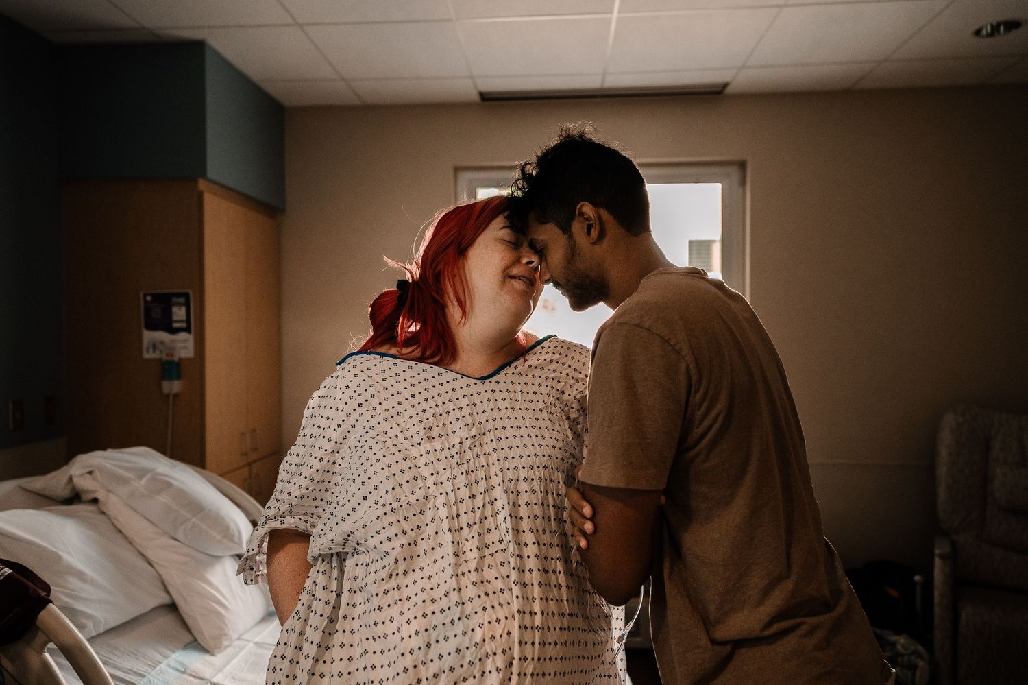 Loving Parents Standing In Labor & Delivery Room