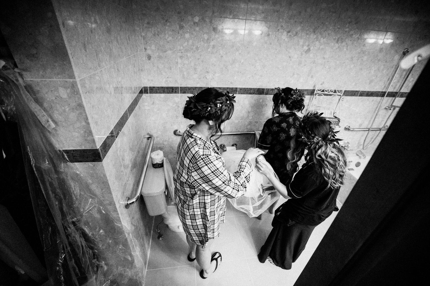 A group walks down a hallway during wedding preparations.