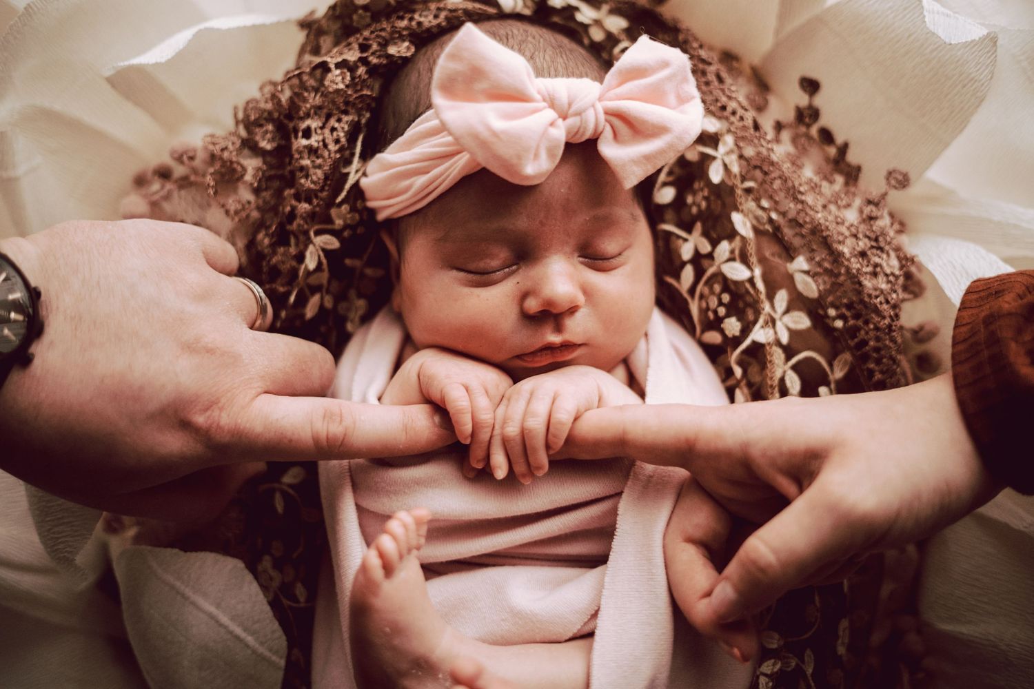 newborn baby girl naturally holding mommy and daddy's fingers during roots & memories studio newborn photoshoot in great