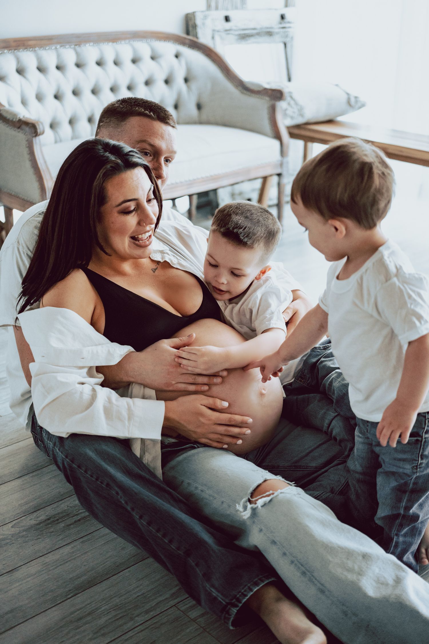 kids touching mommy's belly during roots and memories studio newborn photoshoot in great neck long island