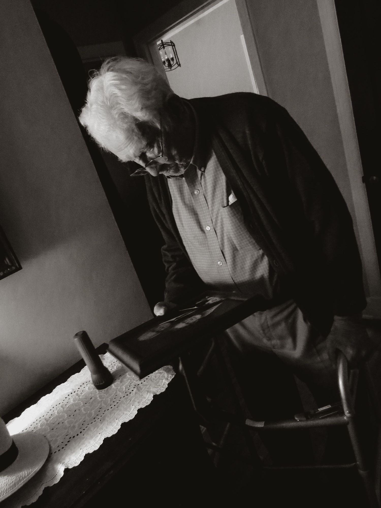 grandfather looking at a portrait of himself and his wife