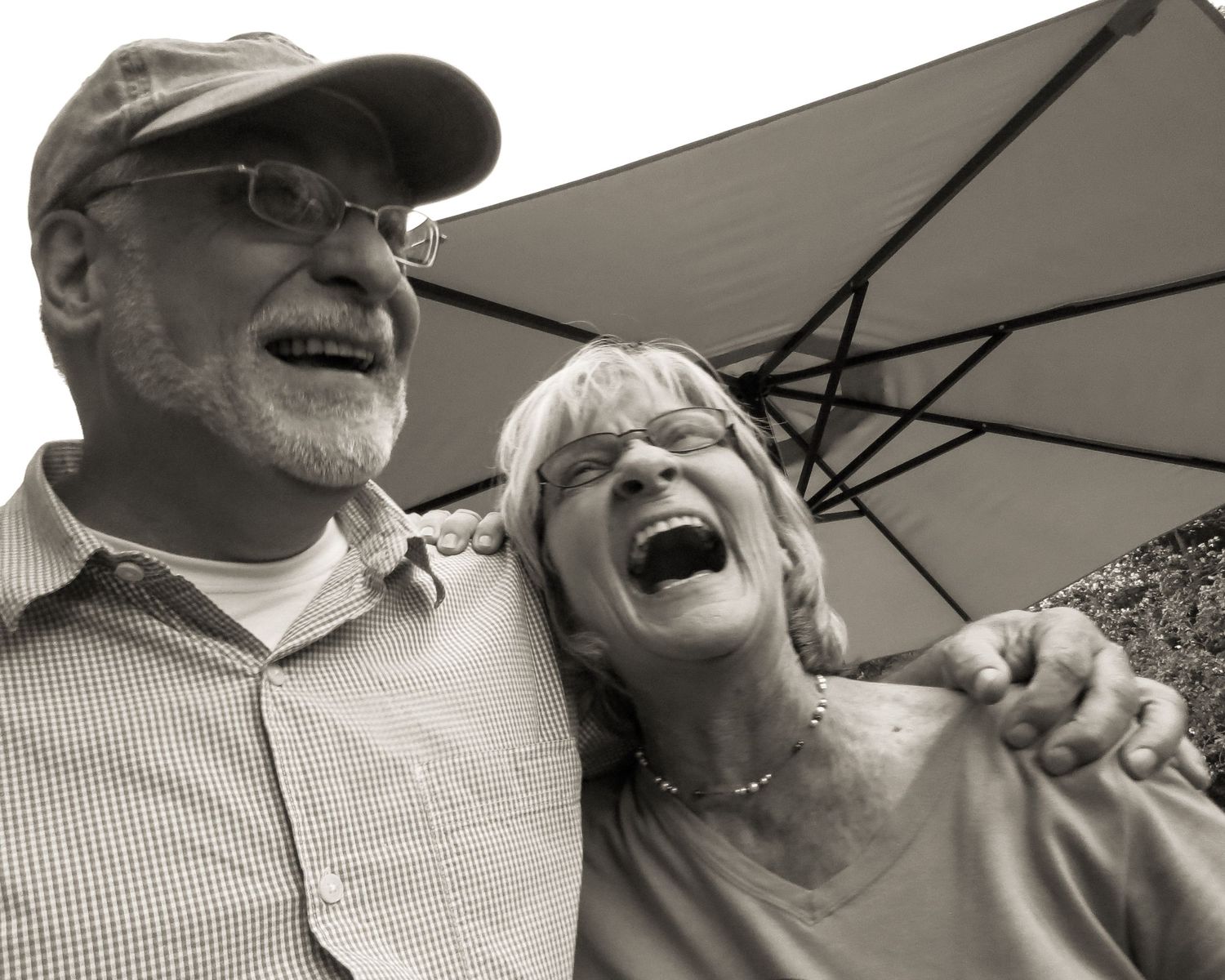 adult brother and sister laughing at a party