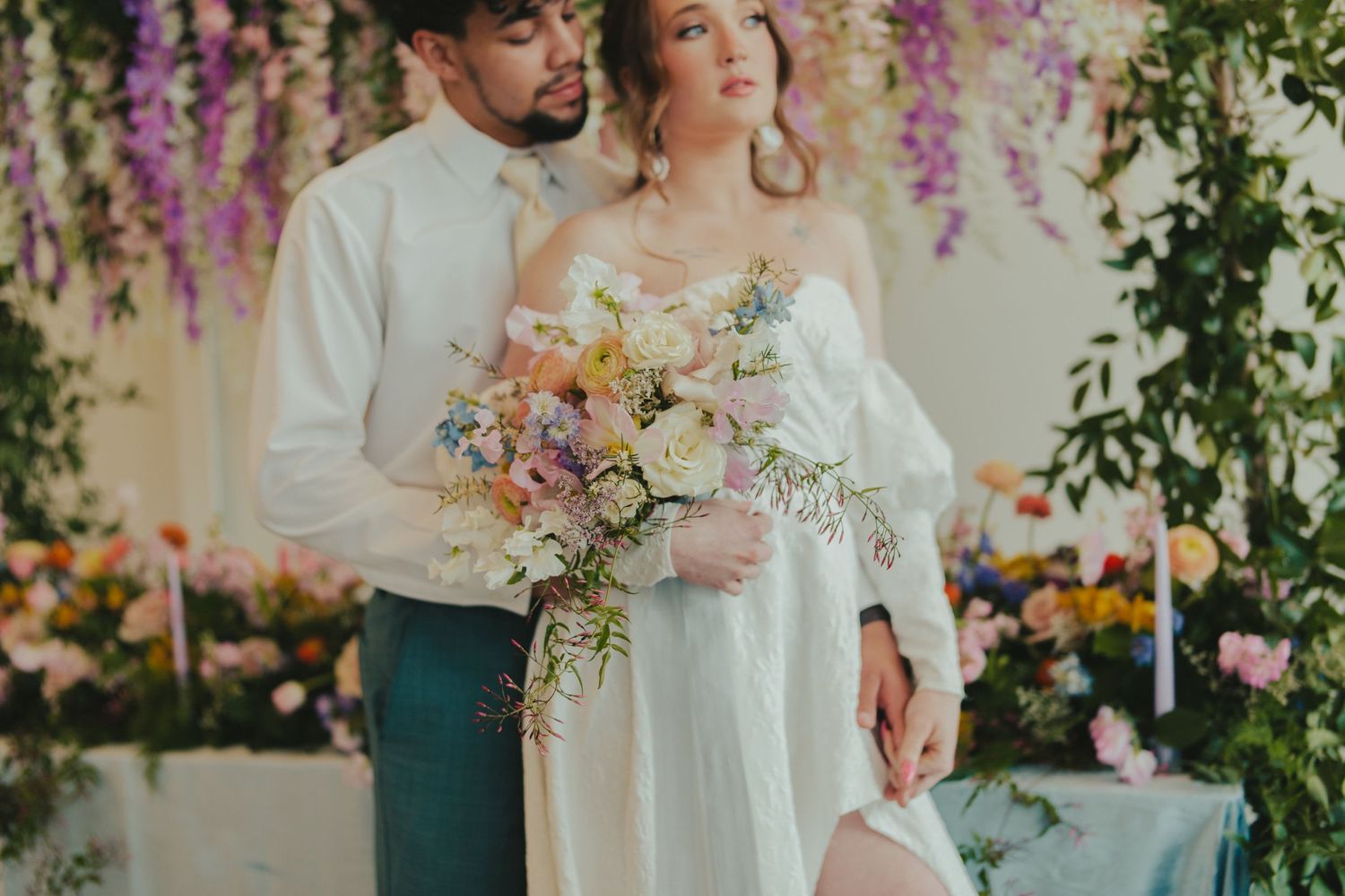 Romantic bridal portrait with pastel bouquet and floral backdrop, captured by a Wichita wedding photographer.