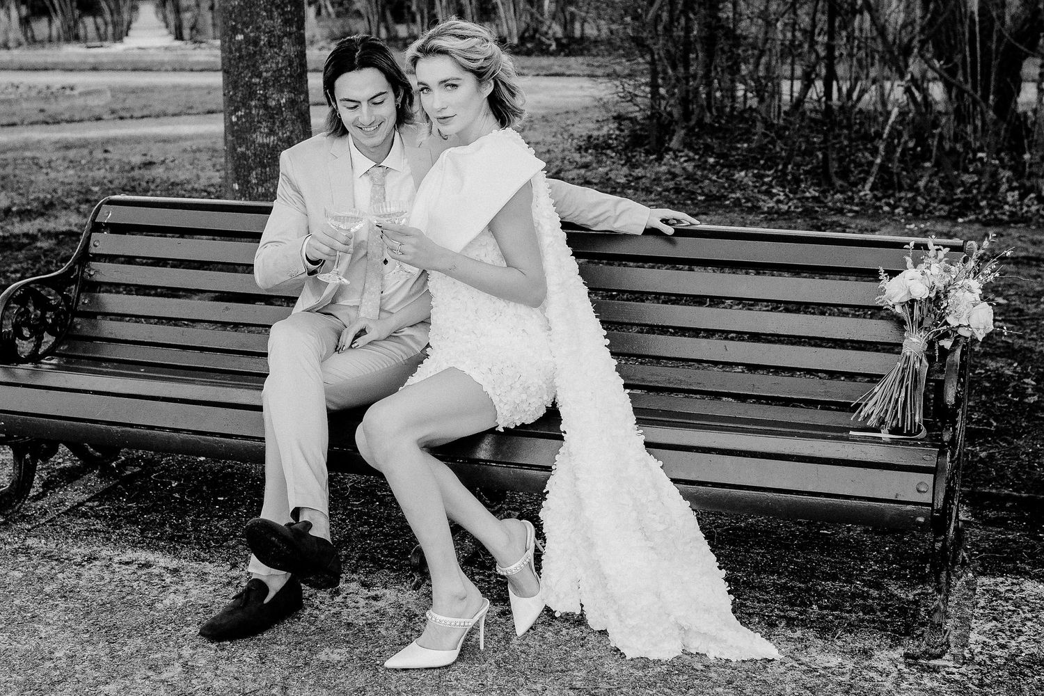 A series of black and white romantic photos showing a couple sitting together on park benches outdoors in London.