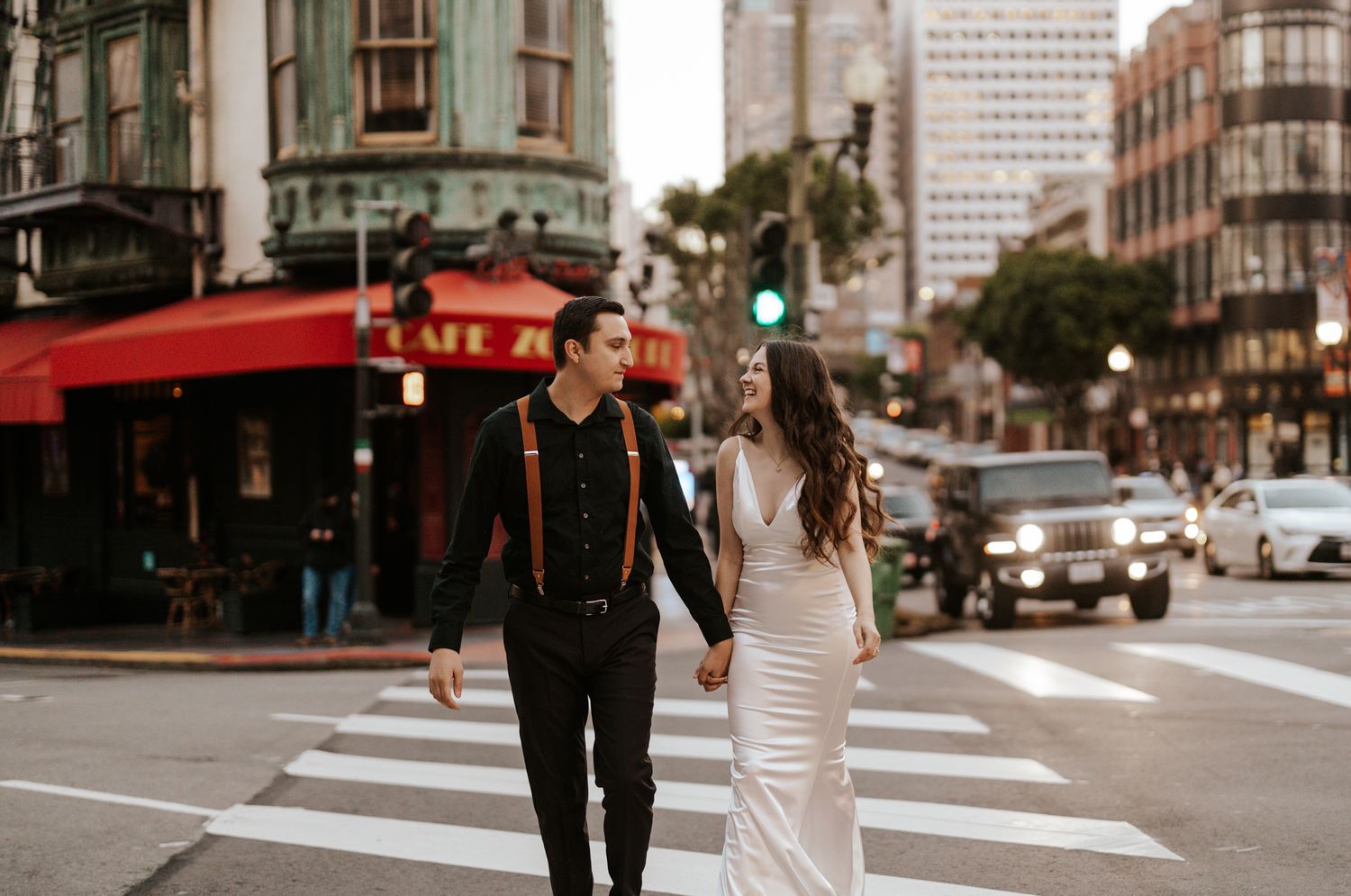 San Francisco Elopement Photographer - bride and groom hand in hand crossing the street while looking at each other