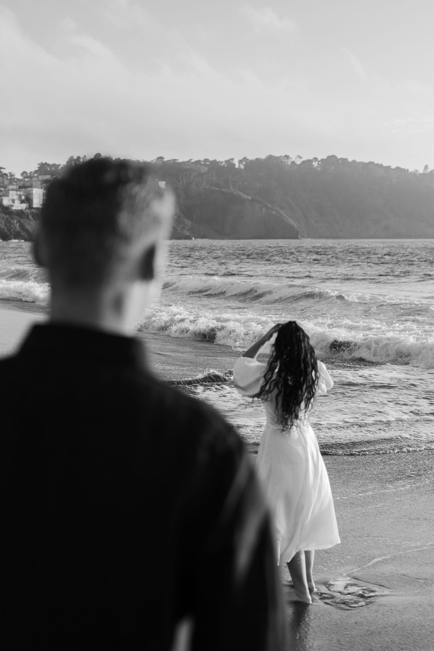 San Francisco Elopement Photographer - fiance looking at his fiance standing on the shore