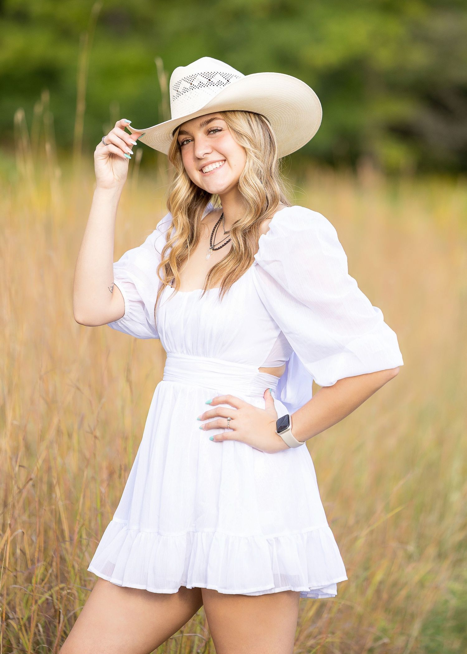 Country Senior photosession standing in field with cowboy hat, Beverly Hills, MI