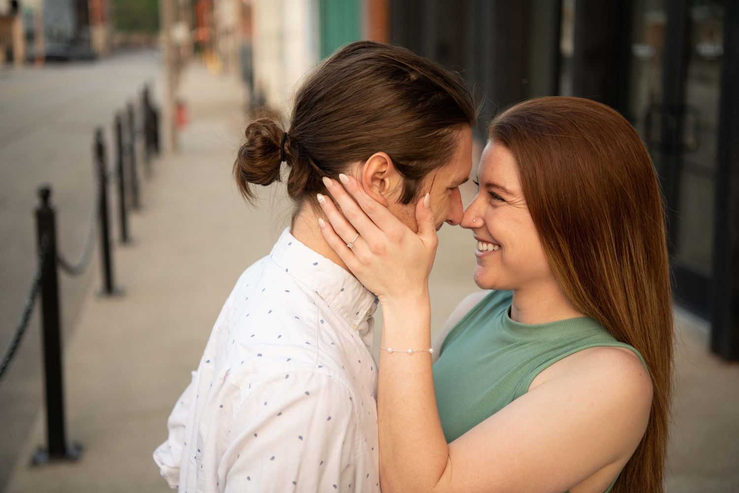 Romantic couple sharing an intimate moment on a city street.