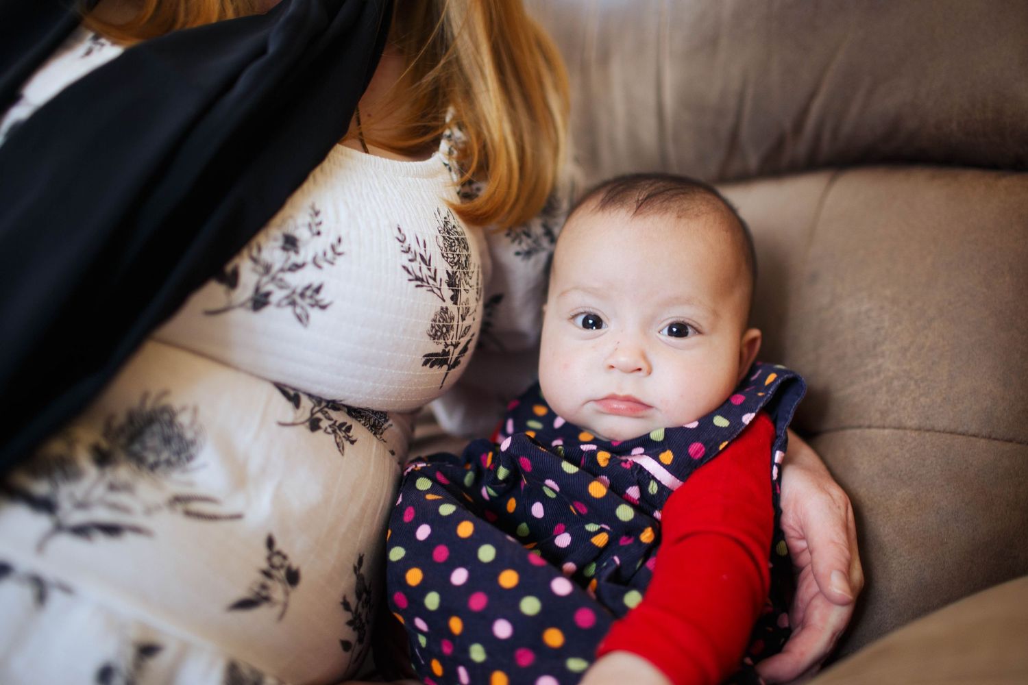 Everett newborn photography: a newborn baby with her mother at an in-home lifestyle family session