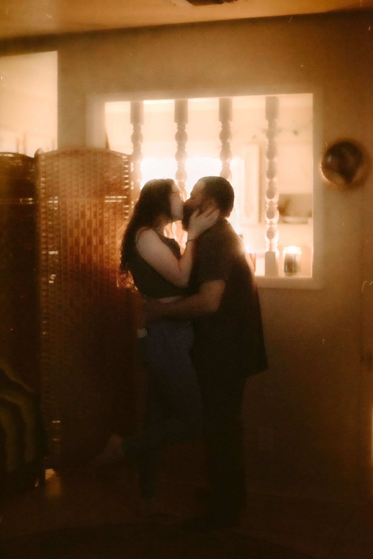 A Couple Kissing by Candlelight in Home in Kenedy, Texas