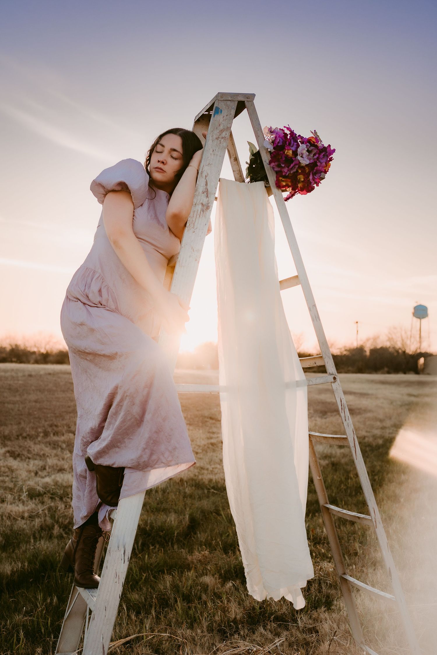 A Person Standing on a Ladder at Sunset in Kenedy, Texas