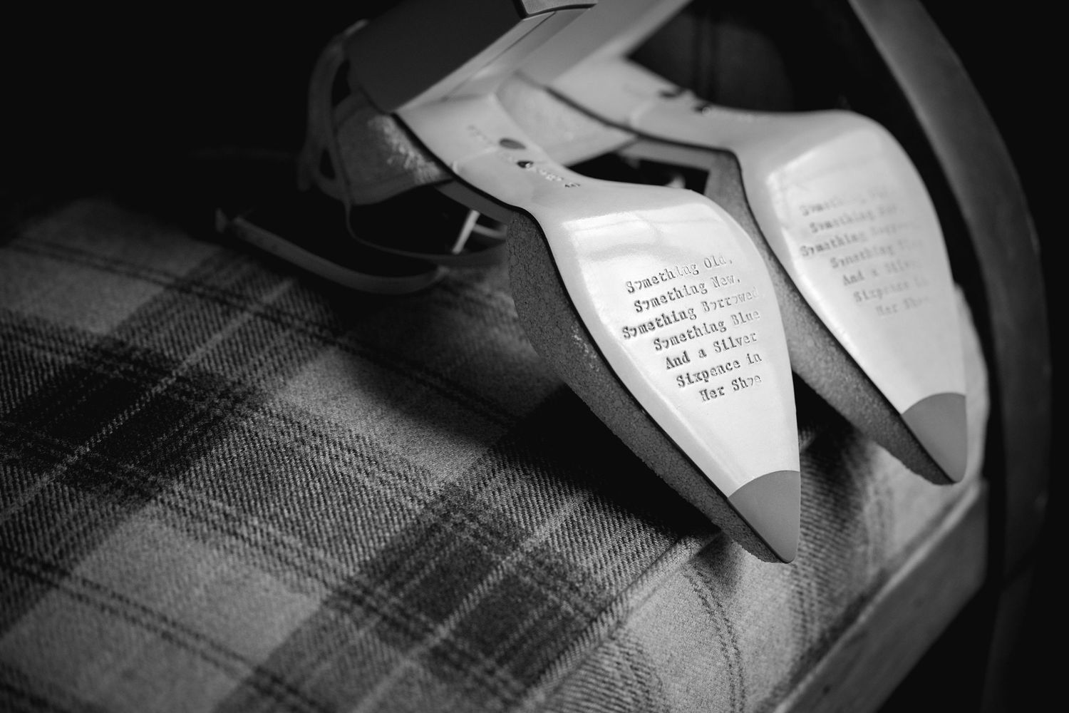 Black and white photo of handwritten wedding vows on paper against plaid fabric.
Preston, Lancashire wedding photographer.