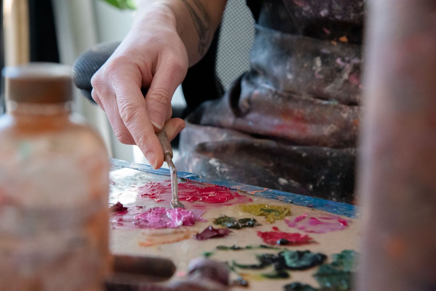 Close-up of art supplies and materials being used on a work surface.