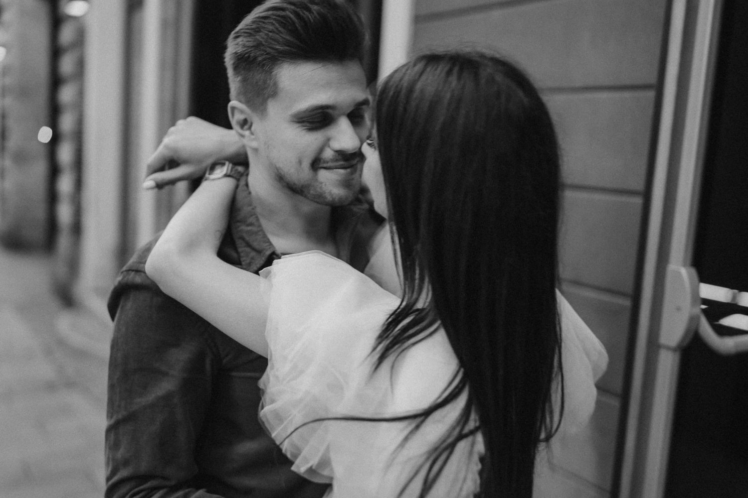Couple sharing an intimate moment together on a city street.