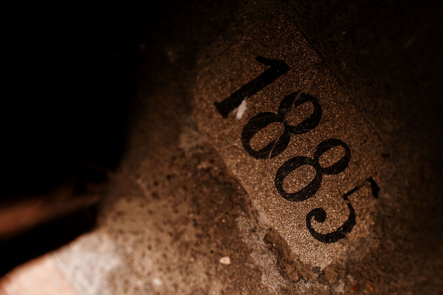 Close-up detail of the number 1885 engraved or carved in stone.