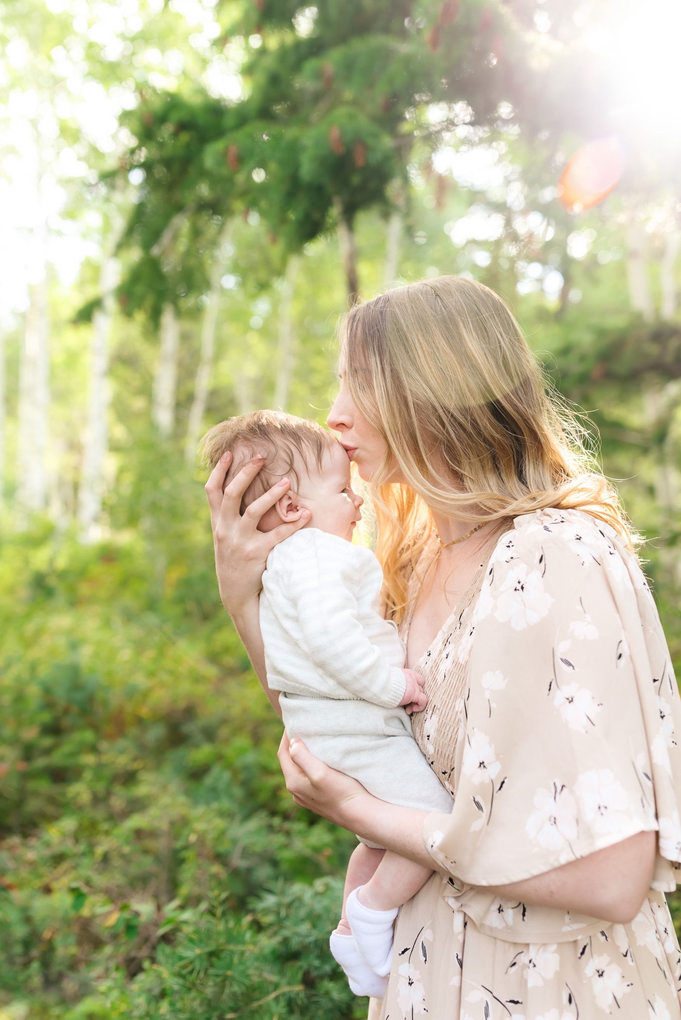A tender family moment captured in a series of outdoor photos with soft natural lighting and greenery.