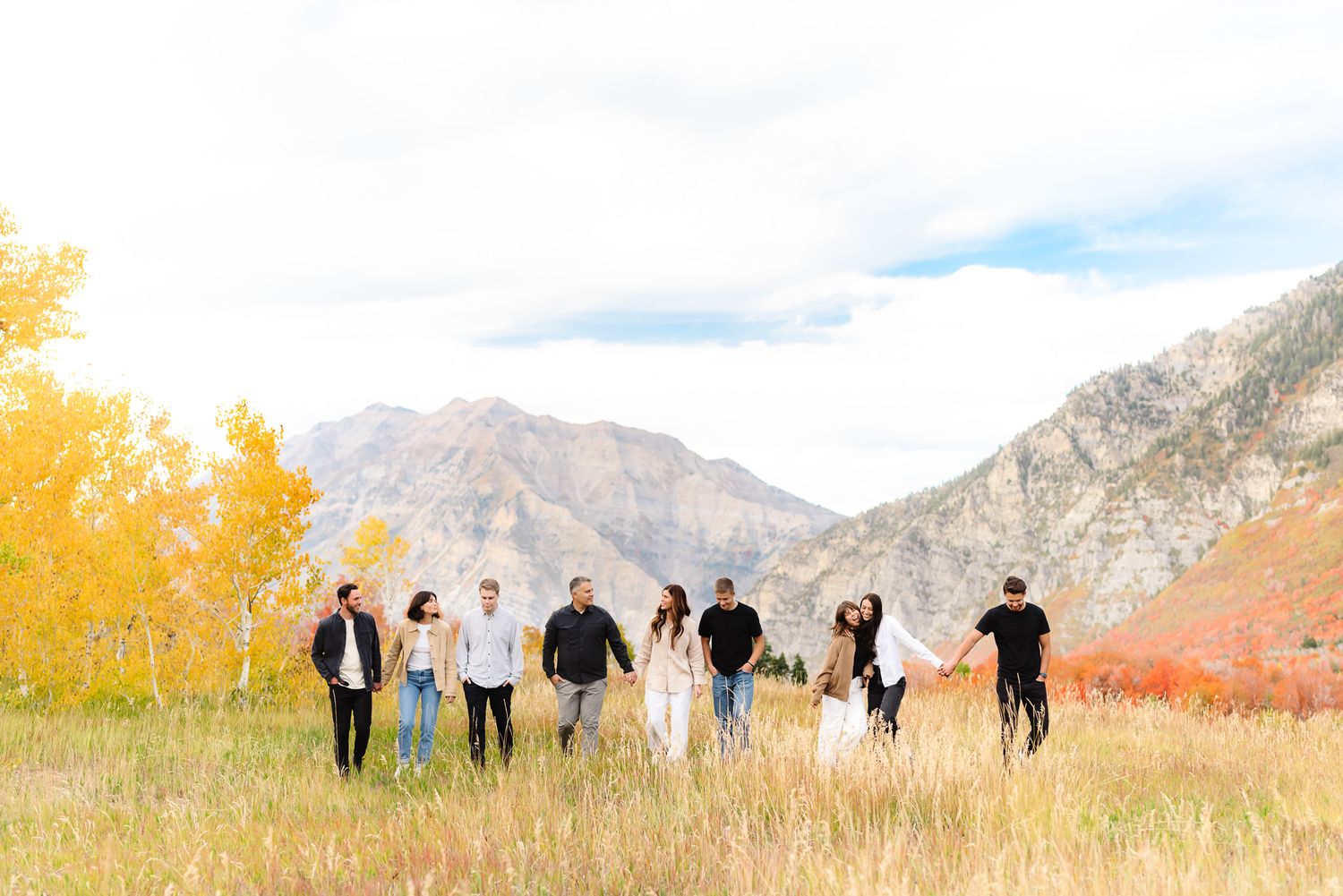 Silhouetted group walking together against a mountain landscape with golden lighting.