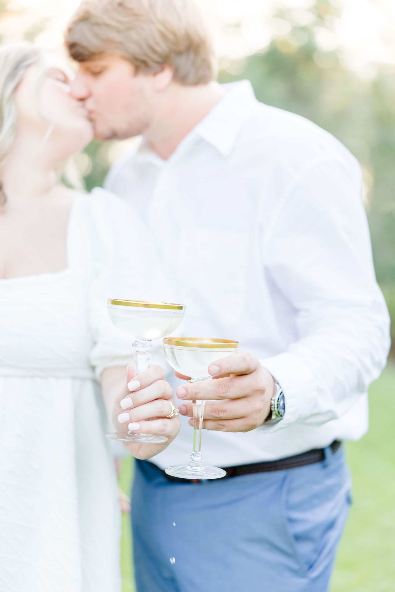 Elegant outdoor champagne toast with soft natural lighting.