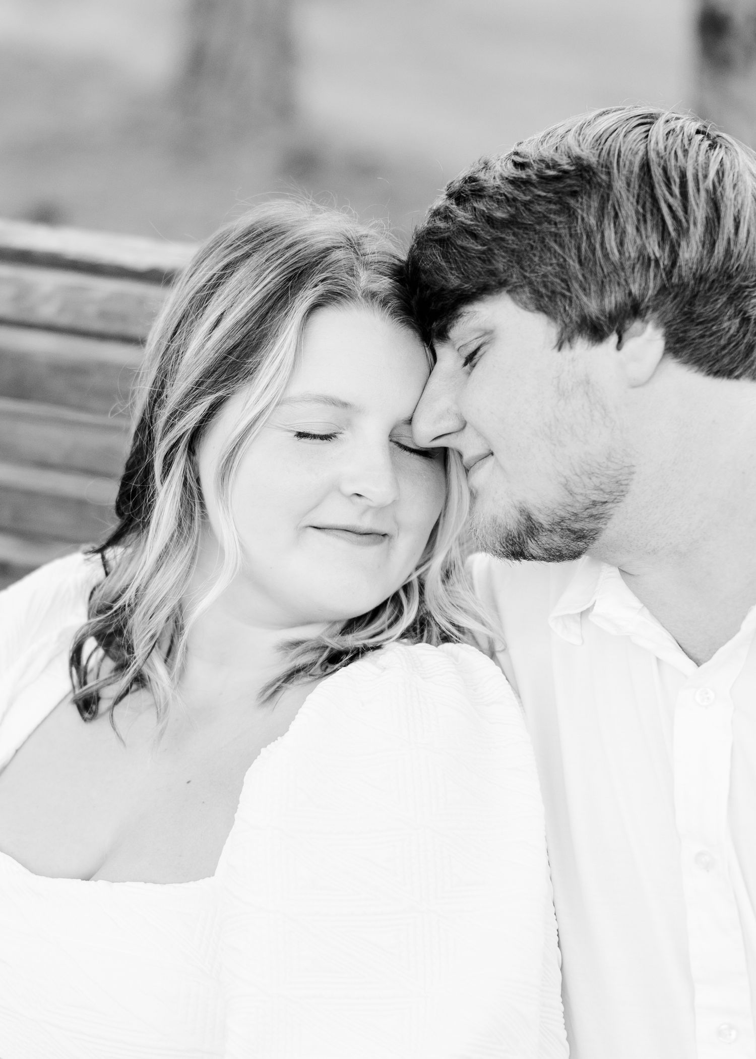 Intimate black and white portrait series of a couple in white clothing.