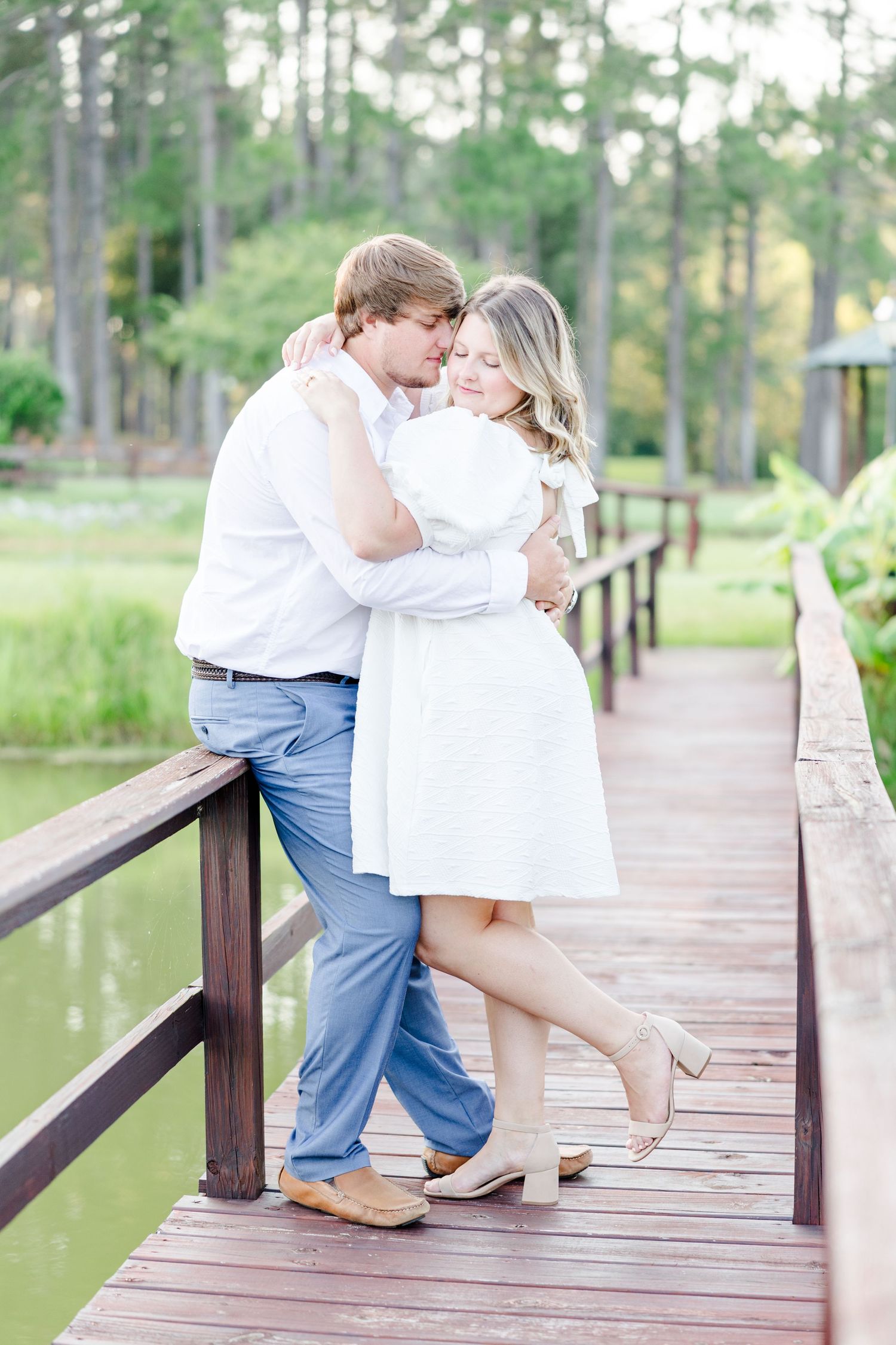 Romantic sequence showing tender embraces on a wooden dock by the water.