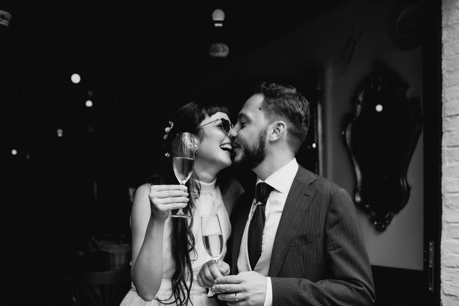 bride and groom laughing kissing drinking champagne Brussels wedding photographer trouwfotograaf