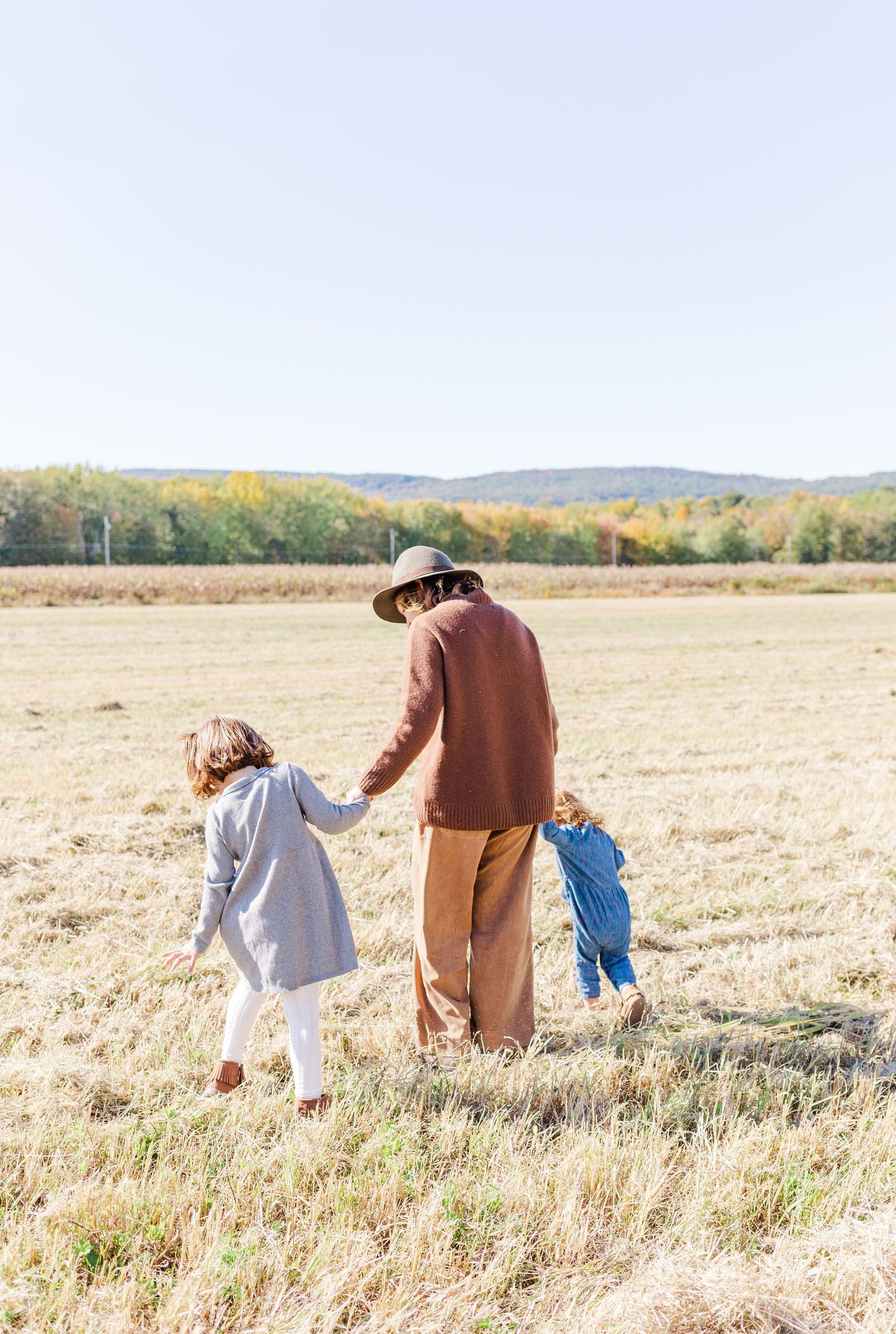Mother and daughters dressed in earth tones during a family session in New Paltz, NY