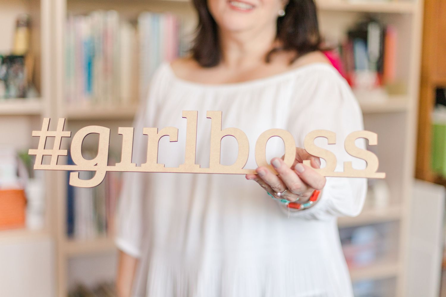 Stationary designer holding a girl boss sign during a brand session in Hudson Valley, NY