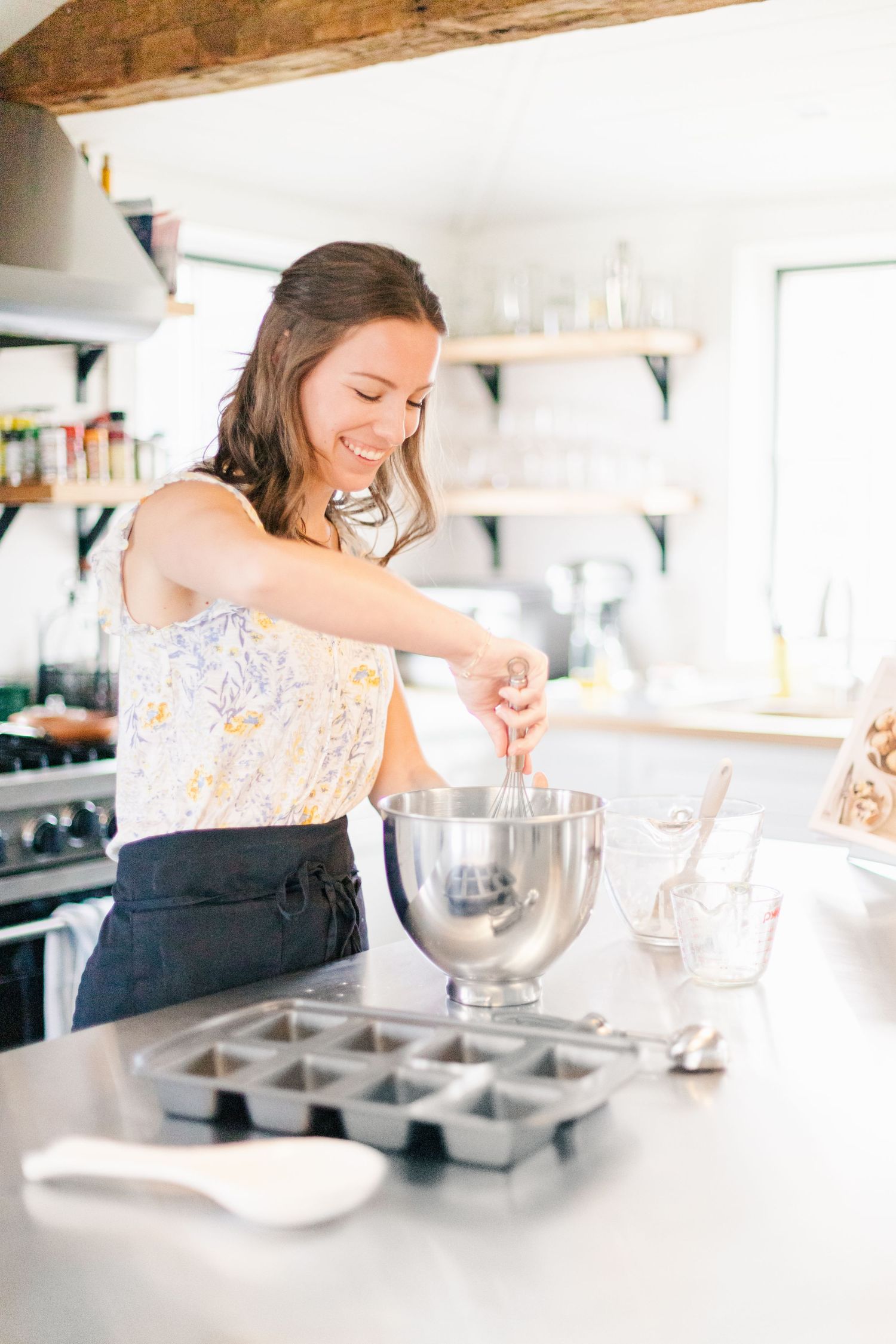 Girl baking in a white farmhouse kitchen during a brand session in New Paltz, NY