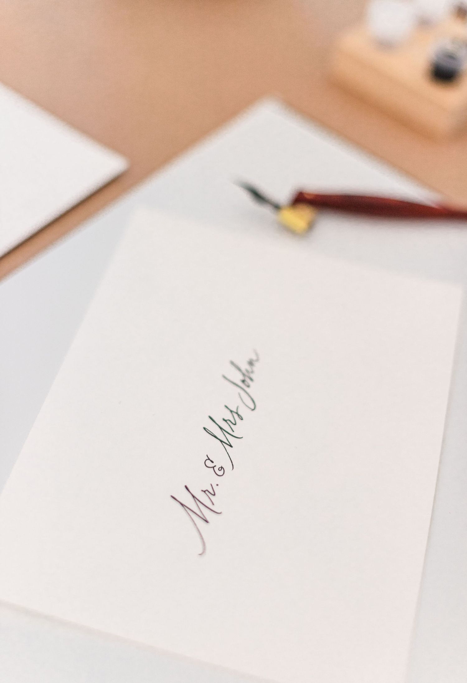 Calligraphy pen and nib laying next to an envelop during a brand session in the Hudson Valley of NY