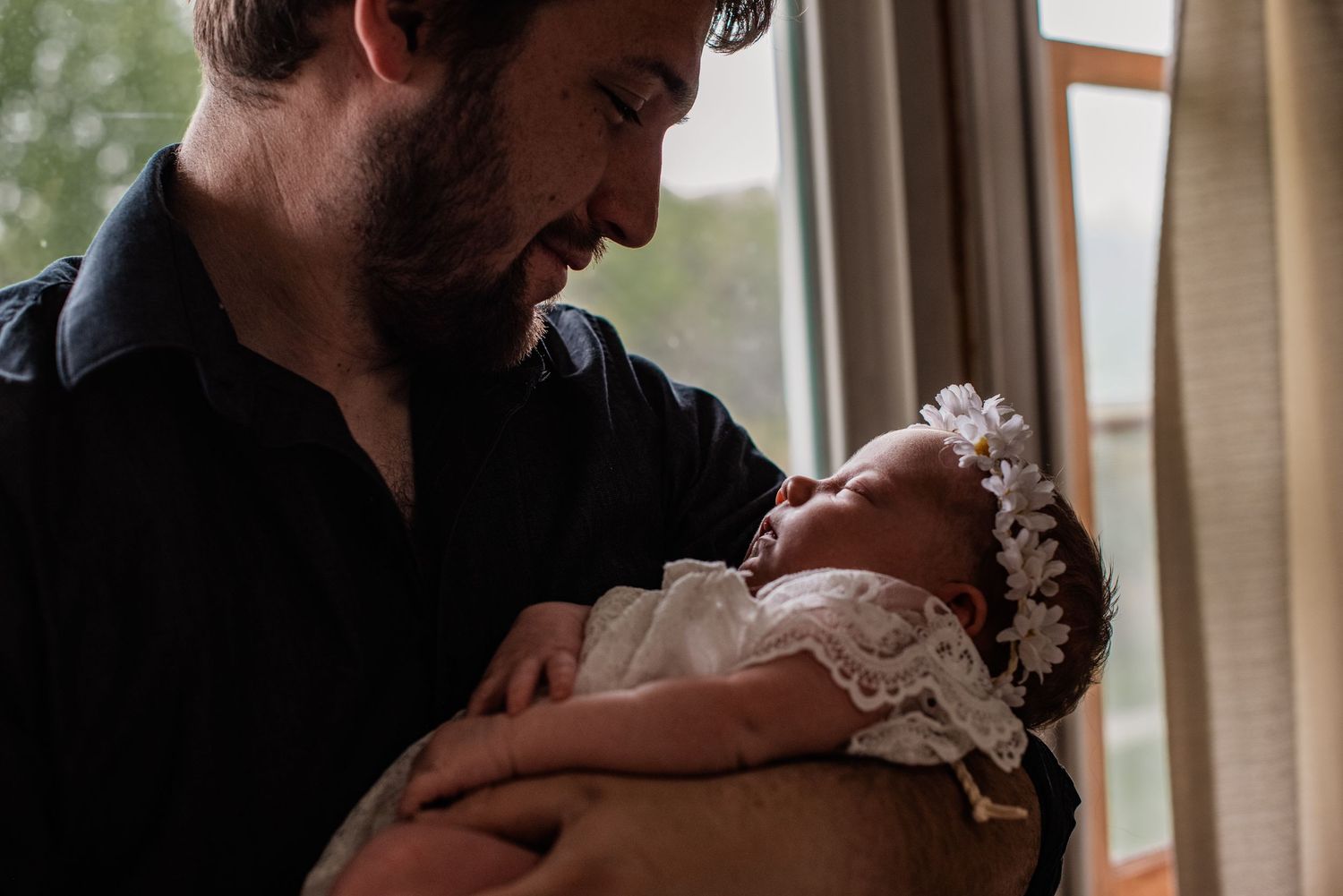 Father lovingly stares into the eyes of his firstborn daughter | west virginia newborn photographer