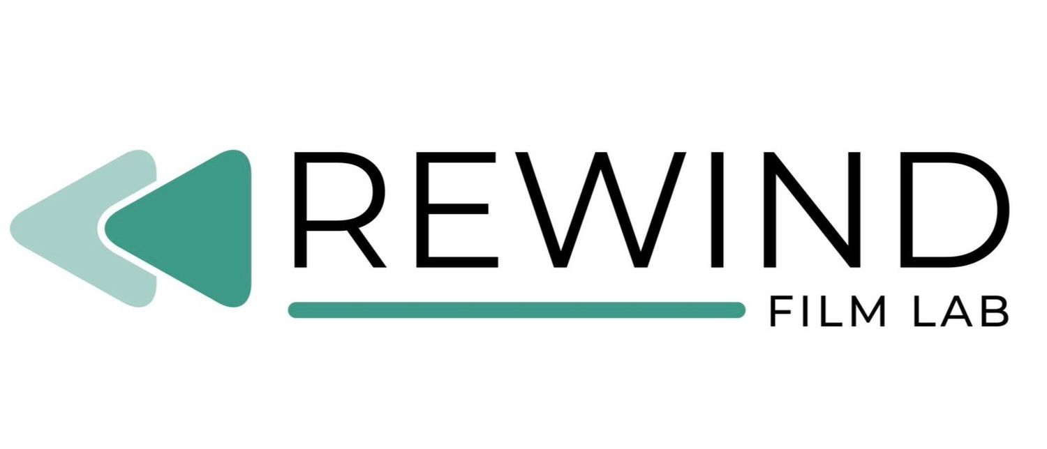 Green triangle rewind icon with film lab text in modern minimal logo design.