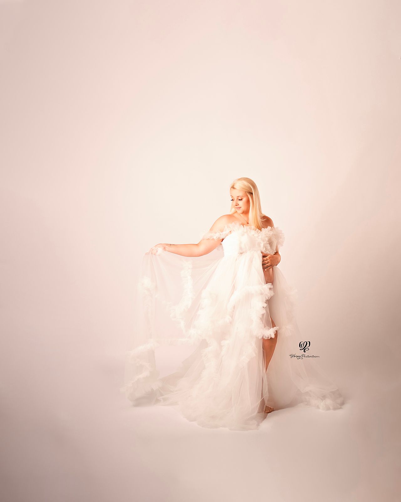 Maternity photo with blonde woman wearing fluffy white tulle dress; Client Closet; Maternity photoshoot; Maternity photo