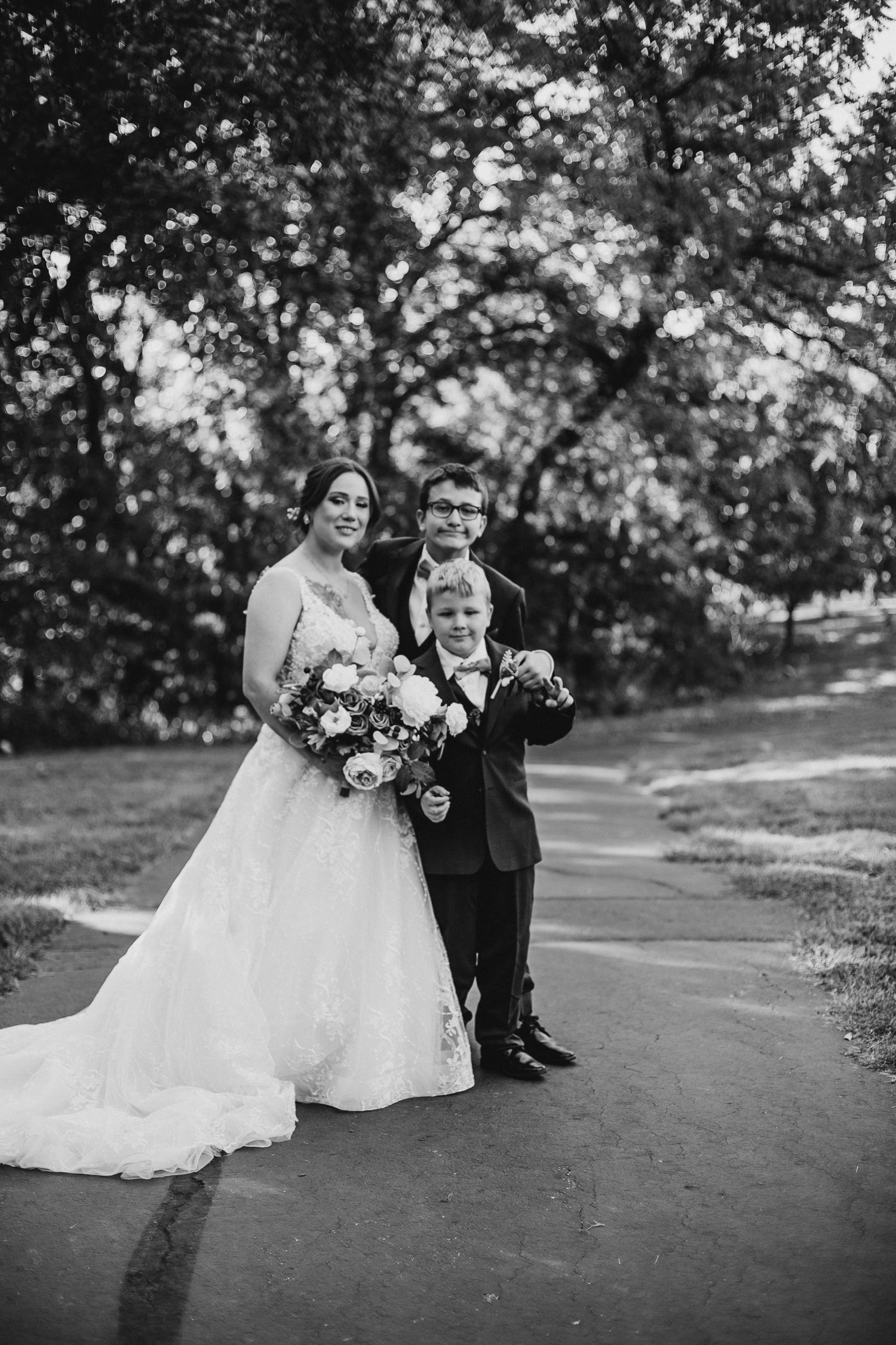 Black and white wedding portraits on a scenic hillside path.
